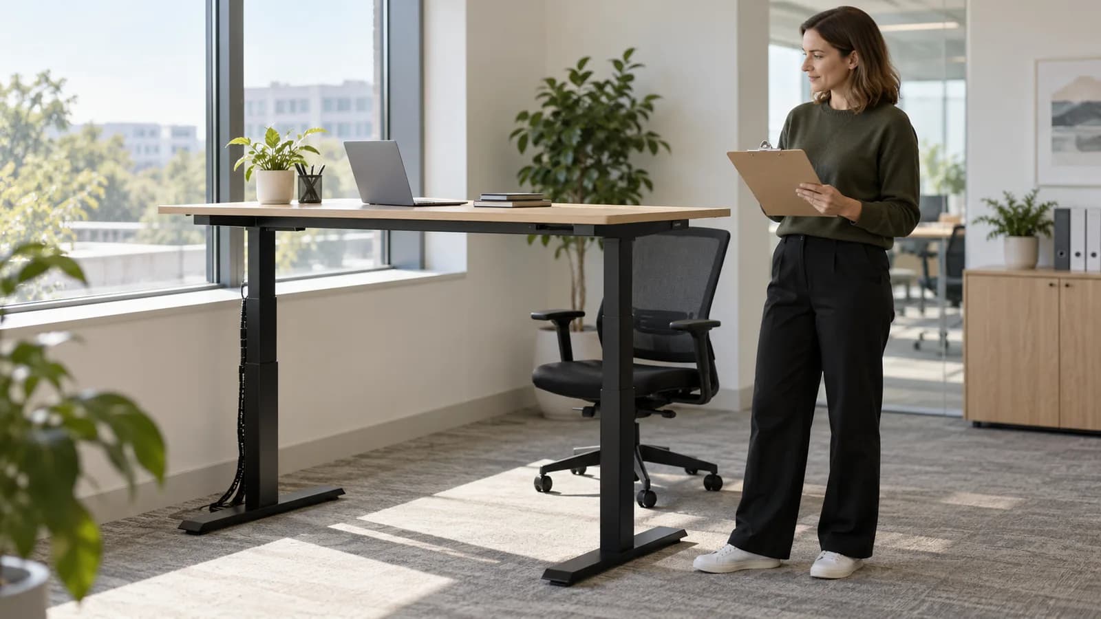 Facilities coordinator observing a generic standing desk and its clear surroundings with an inspection clipboard