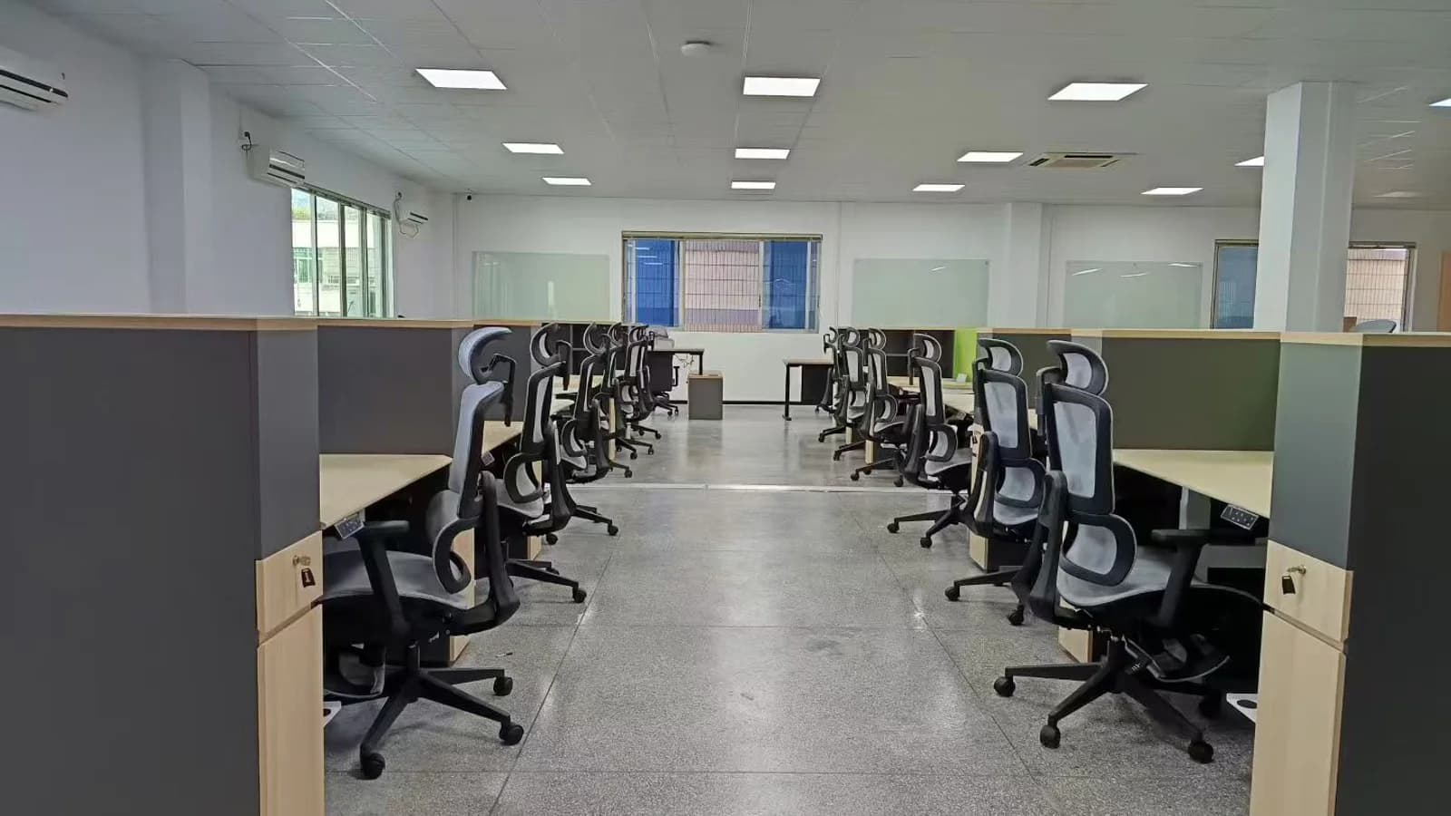 MENBRO office workstations furnished with high-back ergonomic chairs that have adjustable armrests