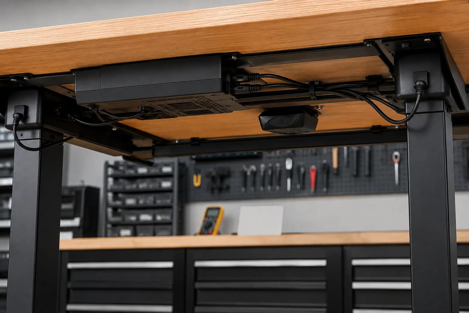 Conceptual underside view of an unbranded standing desk control box, sensor module and cable routing